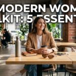 A digital flat-lay of a pearl necklace, a silk scrunchie, and a modern pink cramp relief massager on a minimalist desk background.